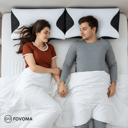 Two people lying in bed with a unique pillow design, holding hands. FOVOMA brand visible.
